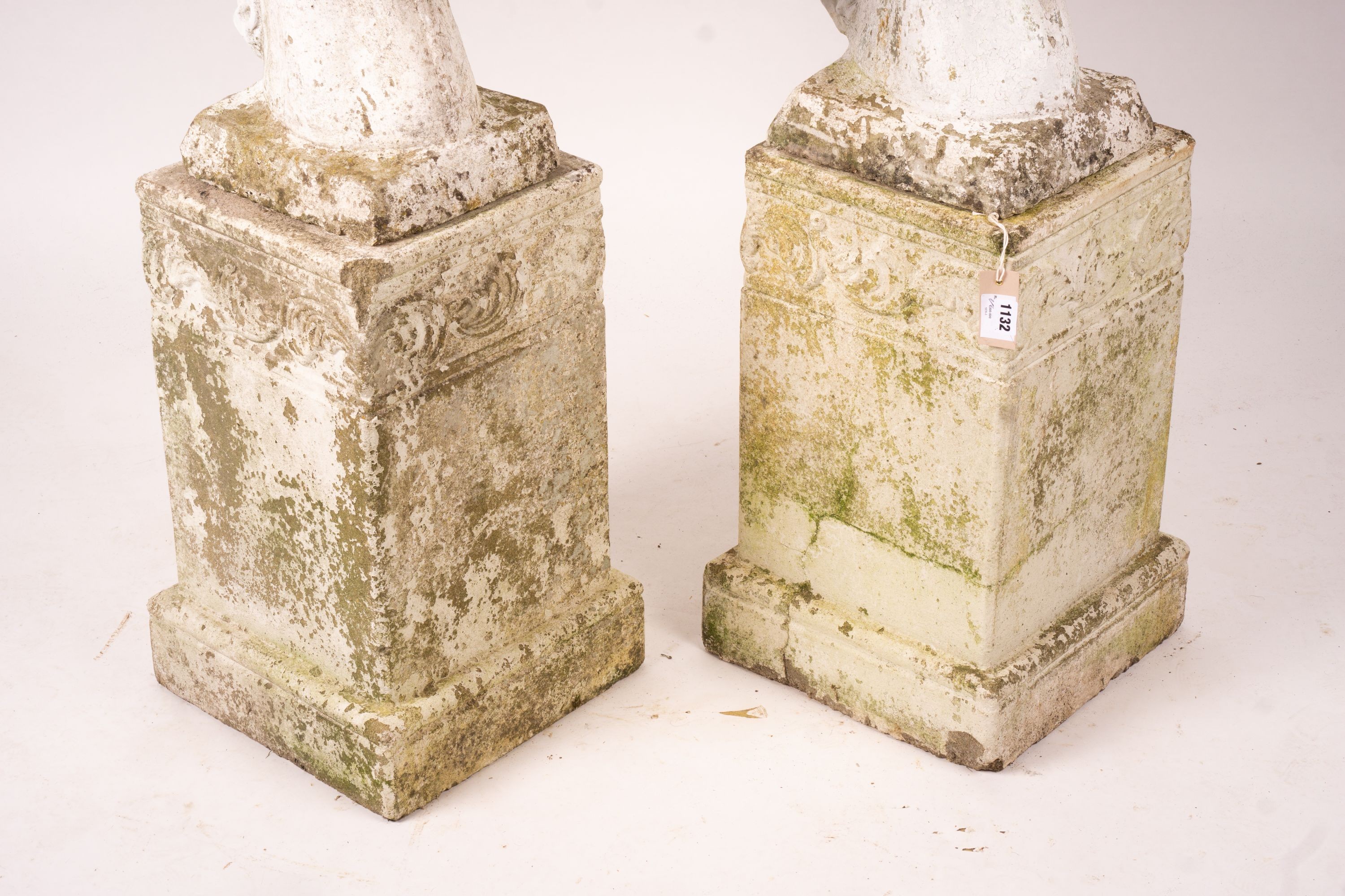 A pair of reconstituted stone horse's heads on plinth bases in the style of Austin and Seeley, height 104cm